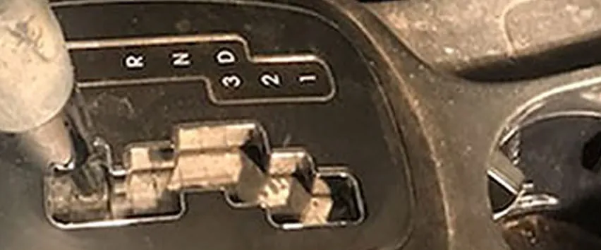 Centre console and gear selector caked in dust and ingrained grime
