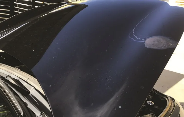 Dark blue paintwork with a visible blemish and dulled surface