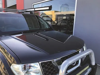 The same ute after cut and polish, bonnet glossy and reflecting clearly