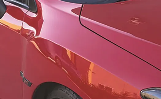 The same red panel after cutting and polishing, reflecting cleanly with no swirls
