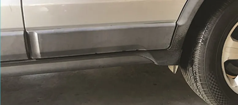 Faded grey plastic side cladding on a silver SUV