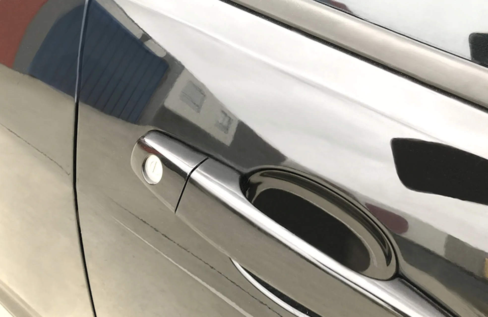 The same door after paint correction, the scratches gone and the reflection sharp